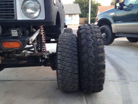 1987 Suzuki Samurai - Comparison of tire sizes on a Suzuki Samurai, showing its front wheel and tire next to a much larger tire.