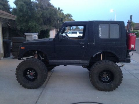 1987 Suzuki Samurai - This heavily modified SUV features large off-road tires and a rear-mounted fuel can.