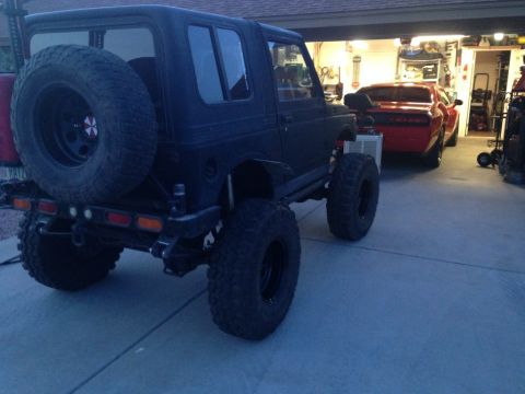 1987 Suzuki Samurai - This modified Suzuki Samurai has a lifted suspension and large off-road tires, suggesting it is not a 1987 model.