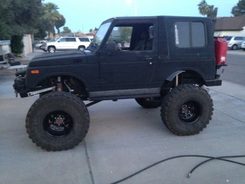1987 Suzuki Samurai - Modified 1987 Suzuki Samurai sits high on large off-road tires.