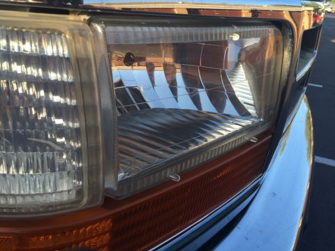 1996 Ford Bronco - Detail of the headlight and amber turn signal assembly on a 1996 Ford Bronco.