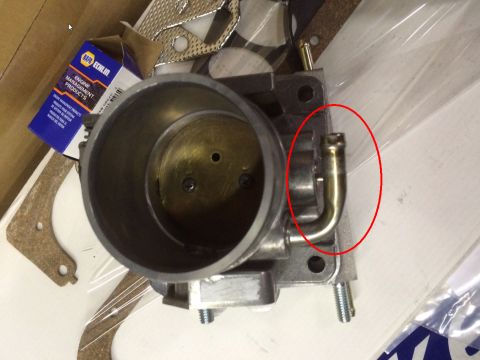 1993 Ford Bronco - Close-up of a throttle body, showing a brass vacuum hose fitting highlighted by a red circle.