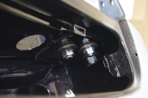 1979 Ford Bronco - Bolts and nuts visible on a vehicle's frame, likely for mounting a component.