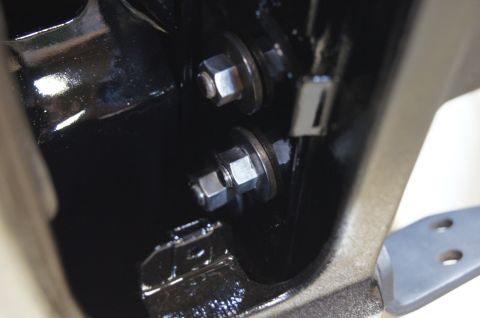 1979 Ford Bronco - Bolts and washers are visible on a dark, possibly painted, metal surface.