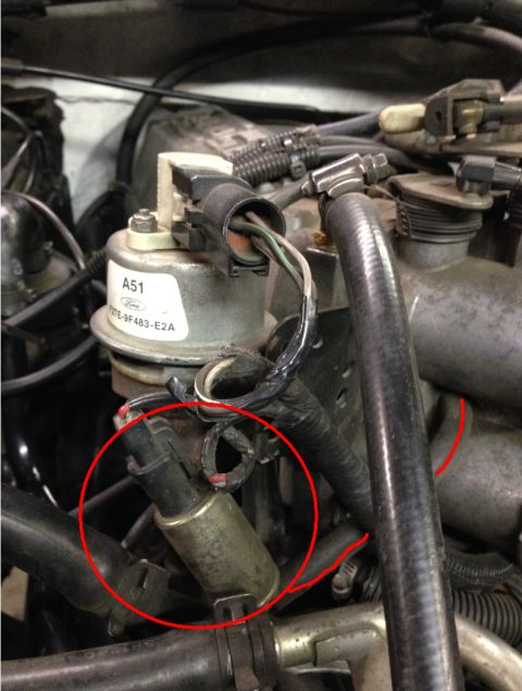 1993 Ford Bronco - A close-up view of a Ford engine component, with a solenoid circled in red.