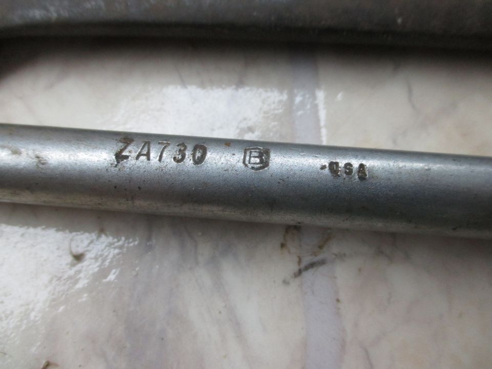 Close-up of a metal rod with markings 'ZA730', a circled 'B', and '-USA'