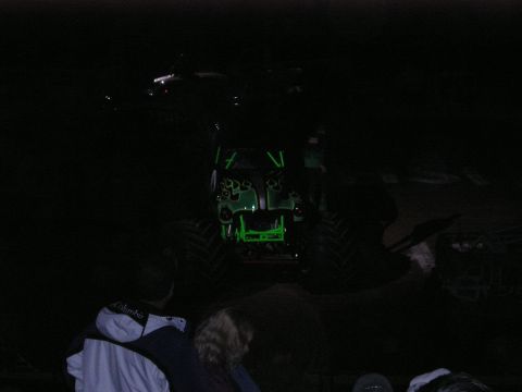 1996 Ford Bronco - Monster truck with neon green accents is seen at an event in the dark.