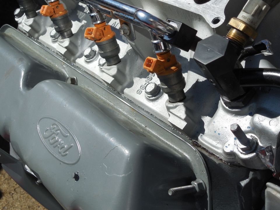 This appears to be a better seal than before, but I'll check this, too, after it all dries.

Note that the stud-head bolt at this corner WILL interfere with the heater outlet (when it's rotated correctly), so it's getting swapped with the normal-head bolt at the rear.