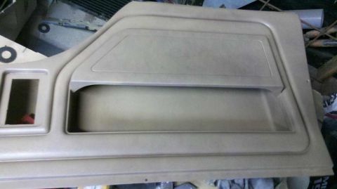 1982 Ford Bronco - Interior door panel for a Ford Bronco, showing storage and speaker cutout areas.
