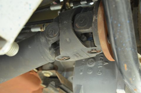 1979 Ford Bronco - Close-up view of a vehicle's drive shaft universal joint, showing part numbers stamped on the bracket.