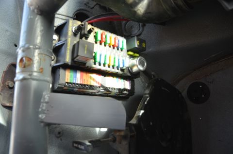 1979 Ford Bronco - Automotive fuse box with various colored fuses and electrical wiring. Part of a vehicle's interior.