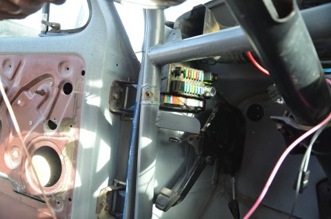 1979 Ford Bronco - Close-up of the fuse box and wiring harness inside a vehicle's cabin.
