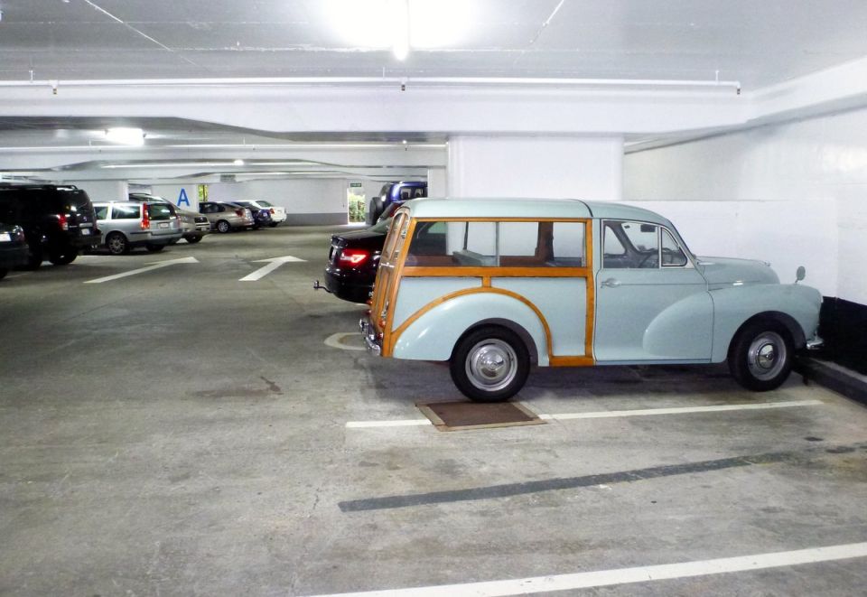 Light blue woody station wagon parked in a garage, side view