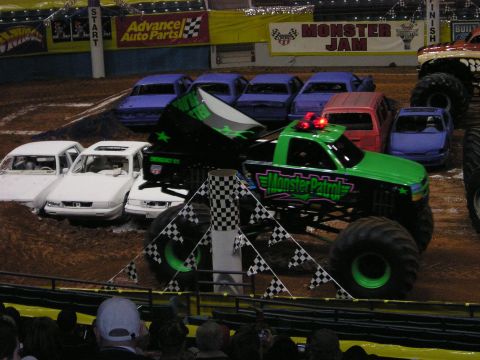 1996 Ford Bronco - Monster Patrol monster truck dominates the arena, crushing cars as part of a Monster Jam show.