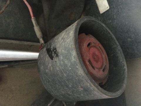 1996 Ford Bronco - A close-up view of an automotive part, possibly a horn or a sensor, with visible wiring.