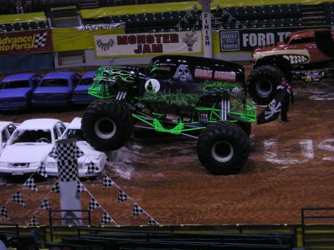 1996 Ford Bronco - A monster truck event with Grave Digger crushing cars and another truck visible.