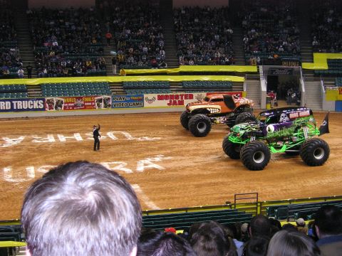 1996 Ford Bronco - Monster trucks are displayed in a stadium during a Monster Jam event.