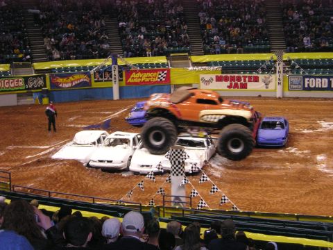 1996 Ford Bronco - A monster truck event with several cars lined up to be crushed.
