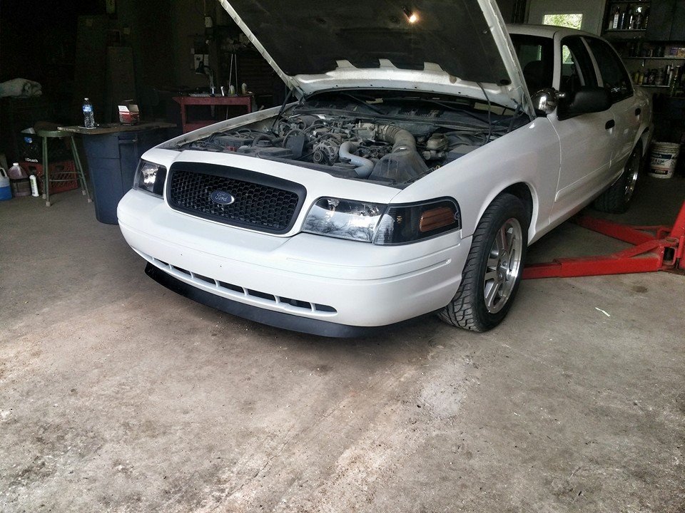 White 2000 Mercury Grand Marquis with hood open, front 3/4 view