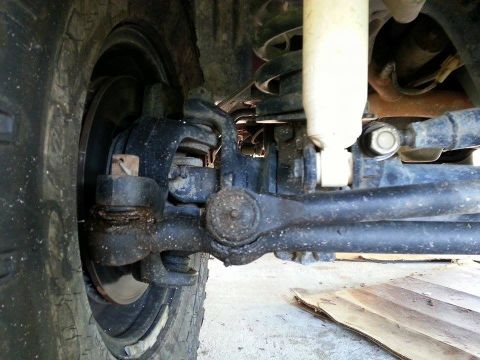 1995 Ford Bronco - Close-up view of the front suspension and steering linkage on a 1995 Ford Bronco.