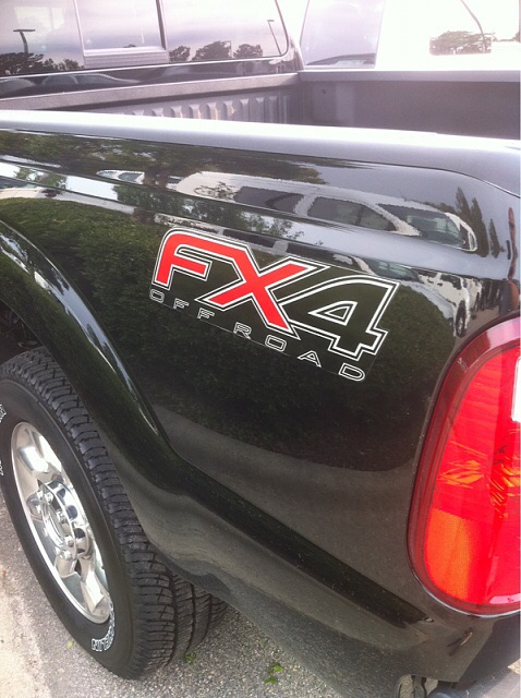 1996 Ford Bronco - Close-up of the FX4 Off Road decal on the rear quarter panel of a black pickup truck.