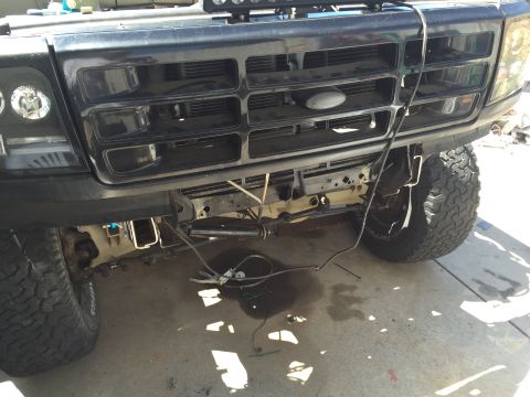 1995 Ford Bronco - Front view of a 1995 Ford Bronco, showing the grille and bumper area with some components exposed.