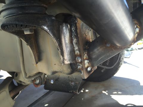 1995 Ford Bronco - Welded suspension parts are visible on a vehicle, with a tire in the background.