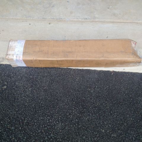 1978 Ford Bronco - A packaged part is shown on the ground, ready for shipping or installation.