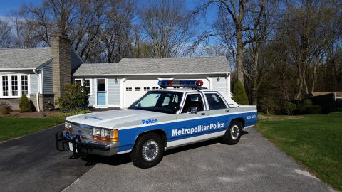 1991 Ford LTD Crown Victoria - This 1991 Ford Crown Victoria LTD police car is parked in a driveway in front of a house and garage.