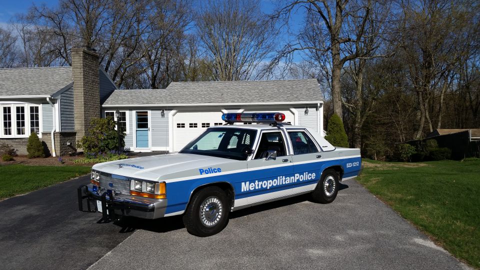 White and blue police car with light bar, marked 'Metropolitan Police'