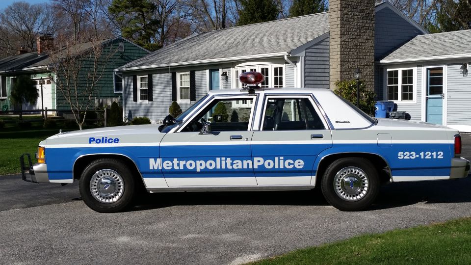 Side view of a 1991 Ford Crown Victoria LTD police car with 'Metropolitan Police' on the door