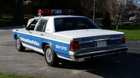 1991 Ford LTD Crown Victoria - Rear view of a 1991 Ford Crown Victoria LTD police car with "Metropolitan Police" markings and a light bar.