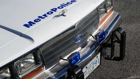 1991 Ford LTD Crown Victoria - Close-up of a police car's front end, a chrome grille and 'Metro Police' markings.