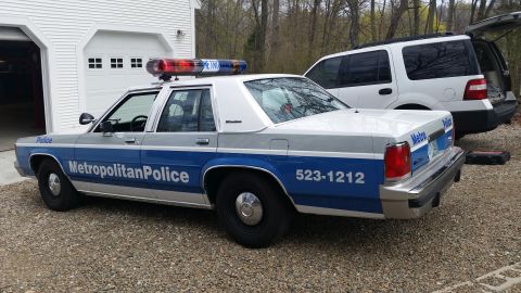 1991 Ford LTD Crown Victoria - This police car has a distinctive boxy body style common in the 1980s, not a 1991 model.
