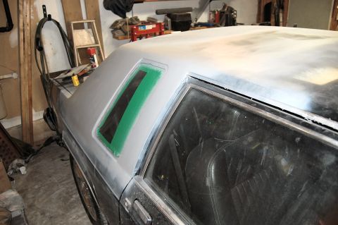 1985 Mercury Grand Marquis - This 1985 Mercury Grand Marquis is undergoing bodywork, with primer gray paint and green tape masking the rear window area.