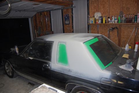 1985 Mercury Grand Marquis - Car undergoing bodywork, with primer applied to the roof and rear sections.