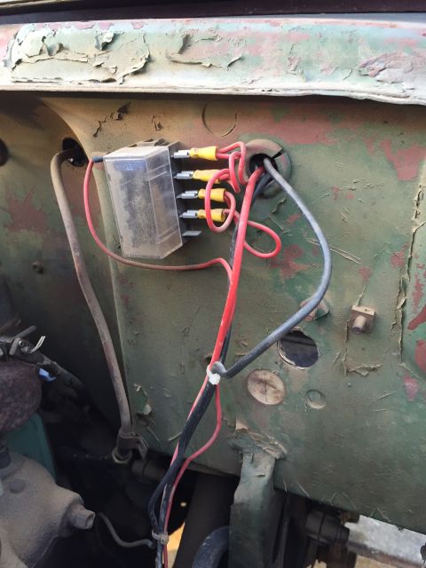 1946 Jeep CJ5 - Close-up of a vehicle's electrical wiring and fuse box, showing a weathered green panel.