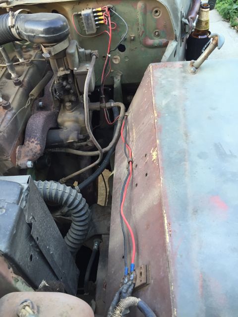 1946 Jeep CJ5 - The engine bay shows exposed wiring and a beer holder attached to the side.
