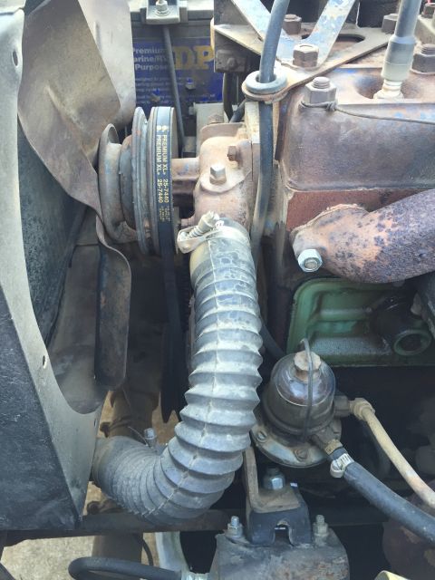 1946 Jeep CJ5 - The engine bay features a fan, belts, and hoses, with a visible fuel filter assembly.