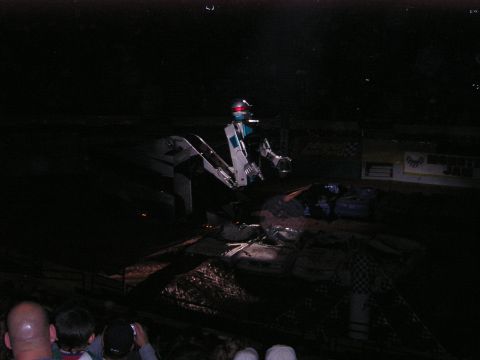 1996 Ford Bronco - A monster truck is seen in action during a show, with the audience visible in the lower portion of the frame.