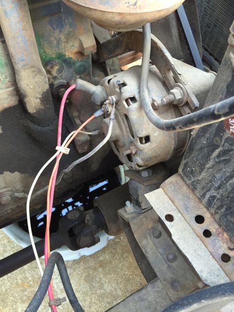 1946 Jeep Willys - This image shows the alternator and associated wiring within the engine bay of a vehicle.