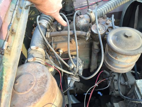 1946 Jeep Willys - Close-up of an engine bay, showing hoses, wires, and a distributor.