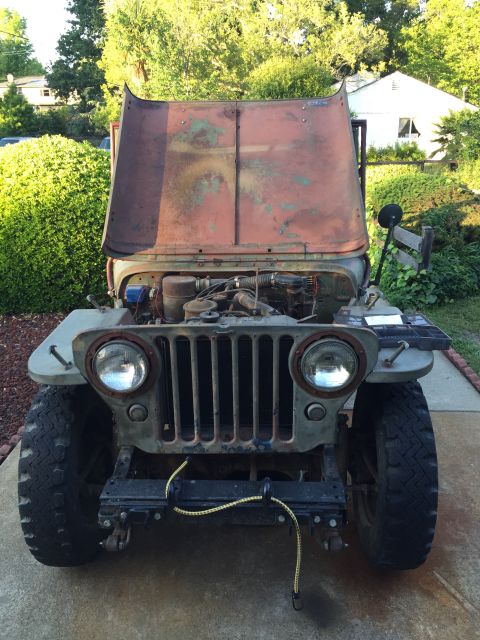 1946 Jeep Willys - This vintage Jeep Willys MB is shown with its hood open, revealing the engine compartment.