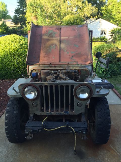 1946 Jeep Willys - This 1946 Jeep shows its engine with the hood open, revealing its age and condition.