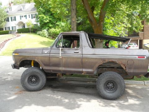 1979 Ford Bronco - This 1979 Ford Bronco shows significant rust on the rear wheel well and has a lifted suspension.