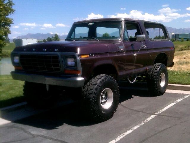 Lifted Ford Bronco with large tires parked in a lot