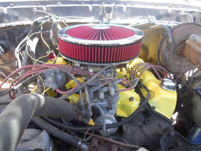 Engine bay with yellow valve covers, red air filter, and visible wiring