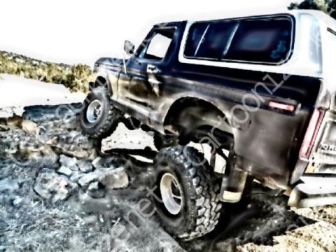 1979 Ford Bronco - Ford Bronco navigates a rocky off-road obstacle course.