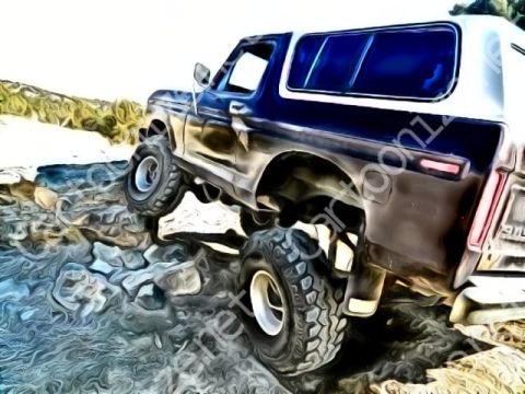 1979 Ford Bronco - This classic Ford Bronco is navigating a rocky terrain, its off-road capabilities.