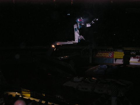 1996 Ford Bronco - A robot is positioned on top of a vehicle during an event, with a checkered flag banner visible.